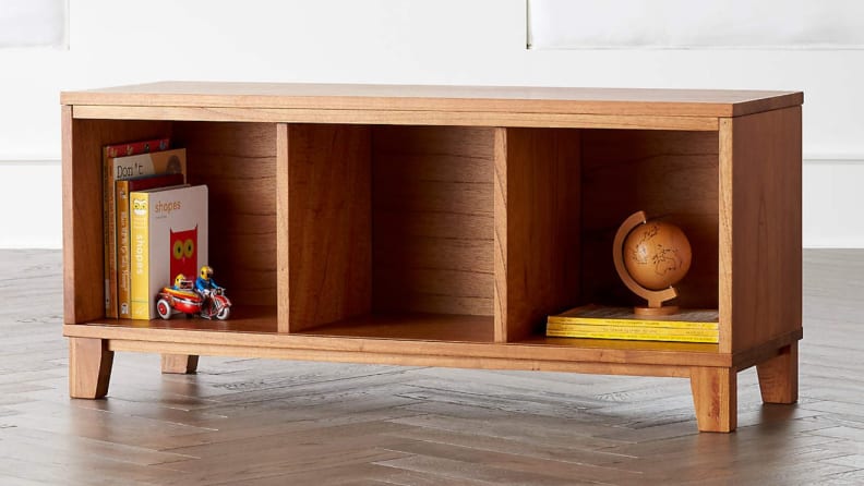 Wooden cube bookcase holding books.