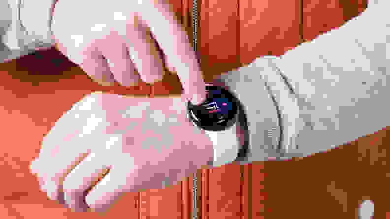 A Man showing the correct placement of a smartwatch, on his wrist.