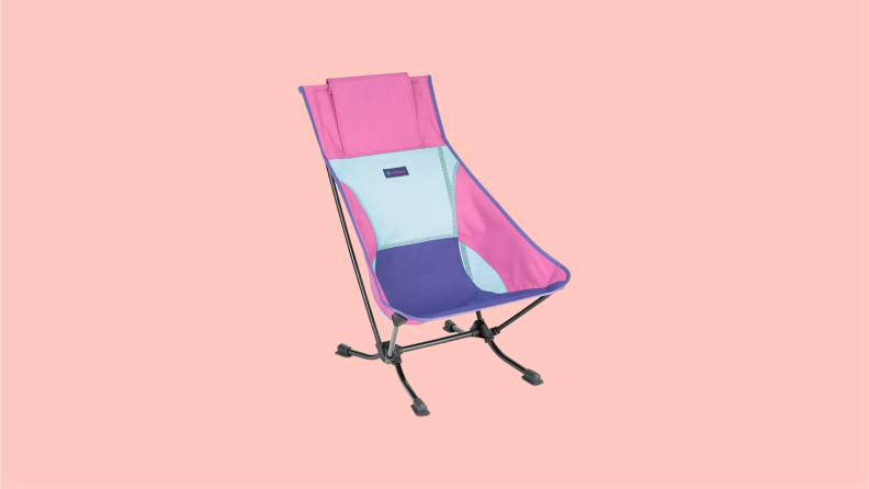 A Helinox beach chair with a pink and blue pattern on the fabric.