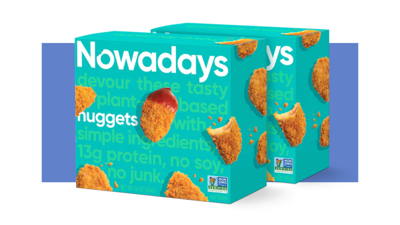 Two boxes of Nowadays nuggets with one nugget that has ketchup on it.