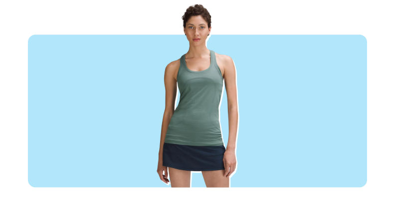 Model wearing the sleeveless teal Swiftly Tech Racerback Tank Top with black bike shorts.