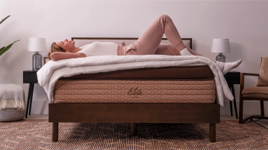 A woman resting on a Helix Elite mattress.