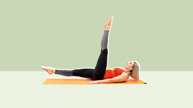 Person lying on their back on a fitness mat with their leg raised.