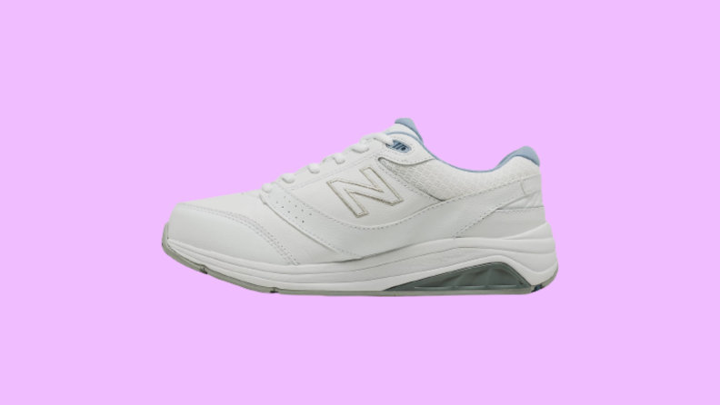 A white and blue sneaker against a pink background.