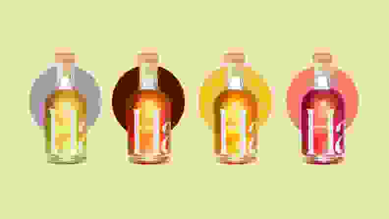 Four bottles of Haus aperitifs against a pale yellow background.