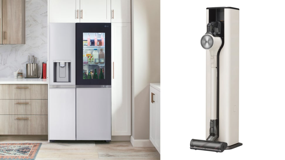 A modern refrigerator has a glass panel and it is opposite a cordless vacuum