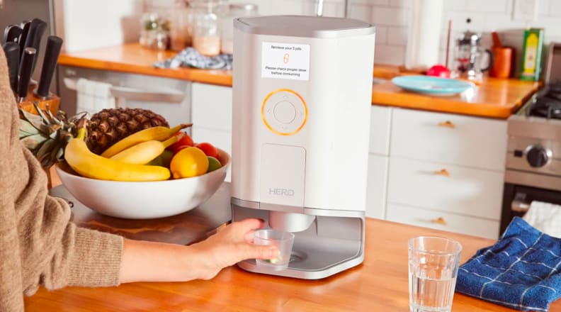 Smart pill dispenser on a kitchen counter