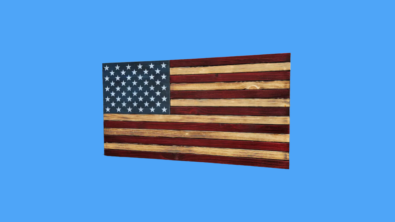 A wooden American flag against a blue background.