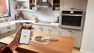 iPhone displaying Whirlpool Air Fry capabilities with modern kitchen in background