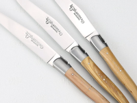 Close-up of three handcrafted Laguiole en Aubrac steak knives.