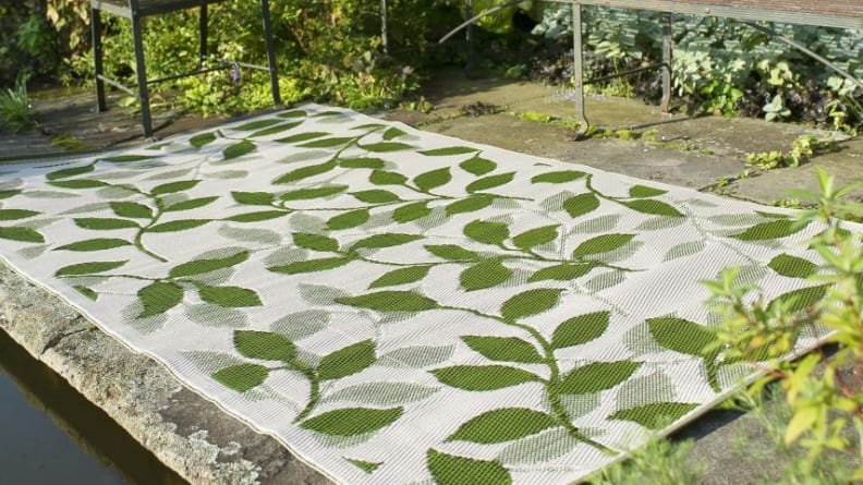A green leafy outdoor rug.