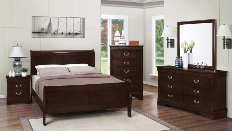 A matching set of bedroom furniture including a sleigh bed.