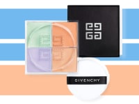 A jar of powder with its lid off to reaveal green, orange, peach, and lavender colors sits with a powder puff next to it.