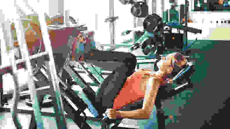 A woman using the leg press machine.