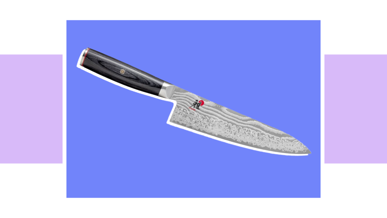 An image of a Miyabi Kaizen II chef's knife, wtih a swirling pattern along the blade and tree-bark detail along the upper blade and handle.