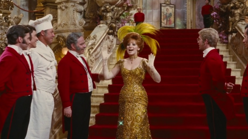 A still from 'Hello, Dolly!" of Barbara Streisand descending a staircase.