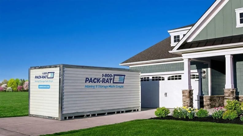 A portable container box in front of a house garage