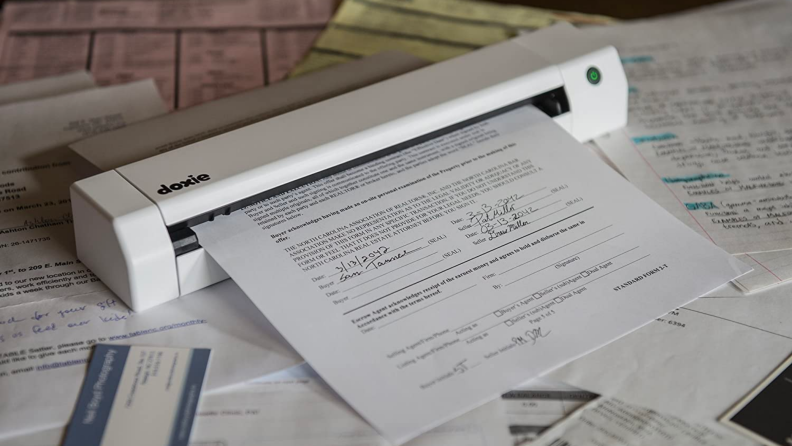 A small digital scanner copies a document.