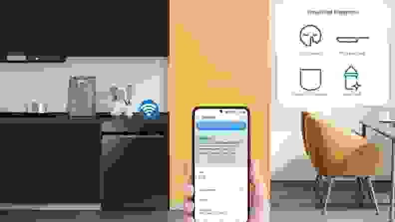 A person holding up a smartphone displaying an app in a kitchen.