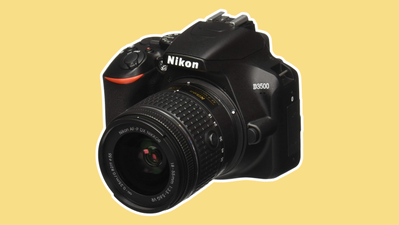 A black Nikon camera on a yellow background.