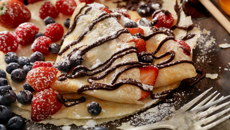 Crepes with Chocolate Sauce, Powdered Sugar, Nuts and Fresh Berries