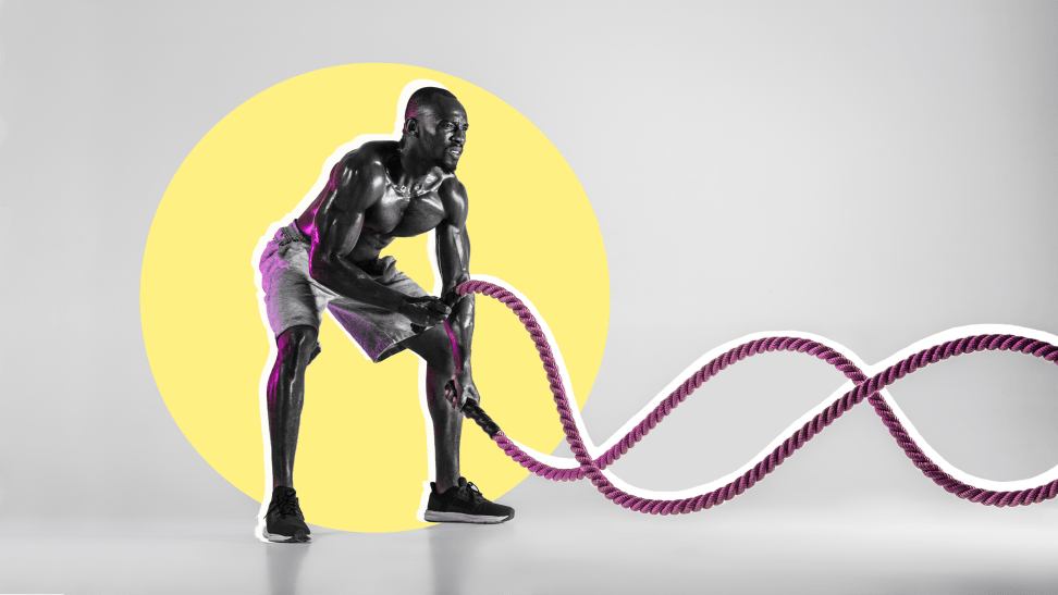 A shirtless person using battle ropes against an abstract yellow and gray background.