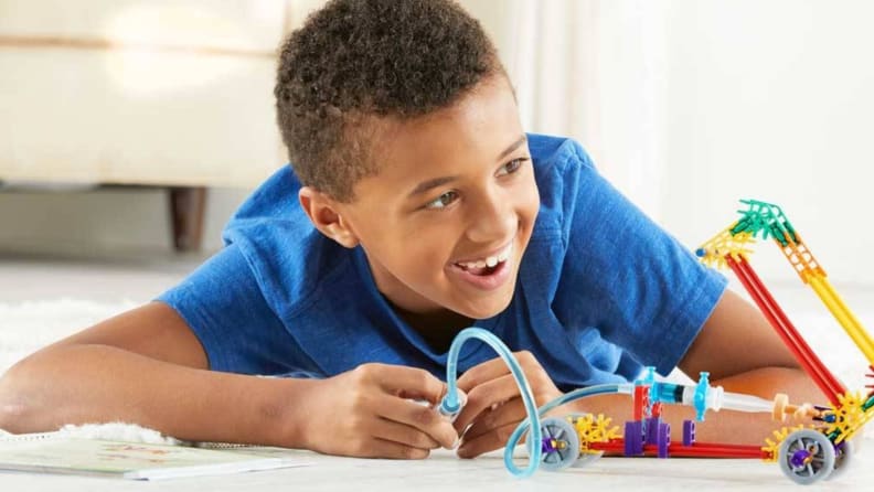 A boy playing with K'nex