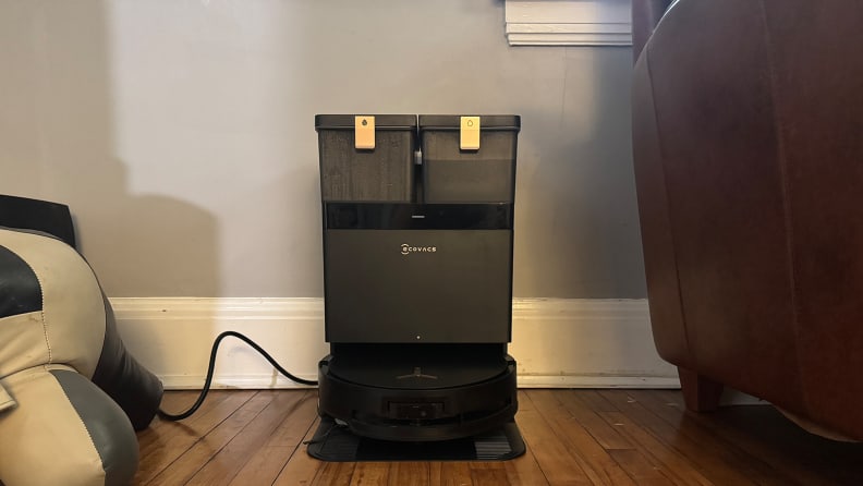A black robot vacuum at its dock station