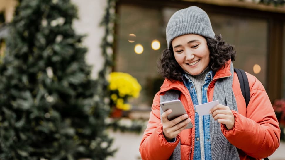 Woman in winter jacket shopping for holiday gifts