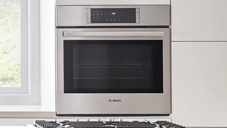 Modern stainless steel oven in kitchen setting.