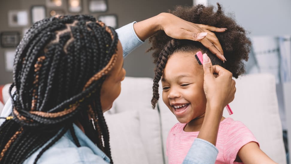 Mom combing daughter's hair