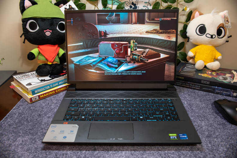 A powered-on laptop showing a colorful scene from a videogame.