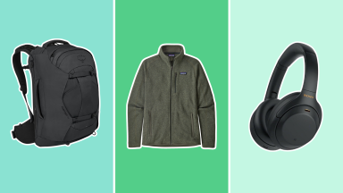 A black Amazon backpack next to a dark green Patagonia jacket, and Sony headphones.