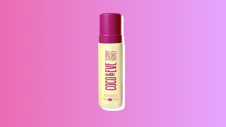Coco & Eve Sunny Honey Bali Bronzing Foam self-tanner against a pink and purple background.