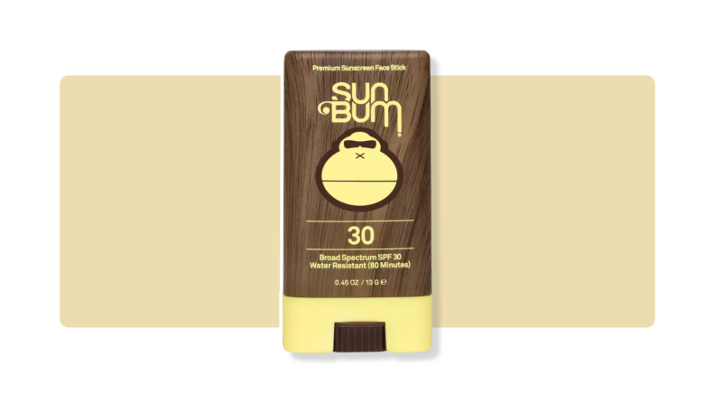 Sun Bum sunscreen stick in front of a yellow background.
