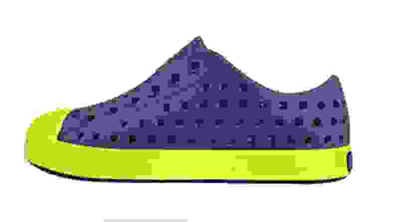 A blue Natives shoe with a bright green sole.