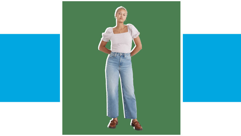 A model wearing wide-leg jeans with a white shirt