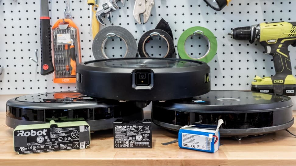 Three batteries in front of their respective robot vacuums.