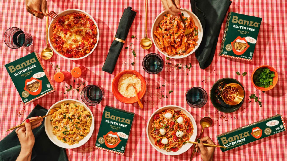 Banza new brown rice pasta dishes on pink background