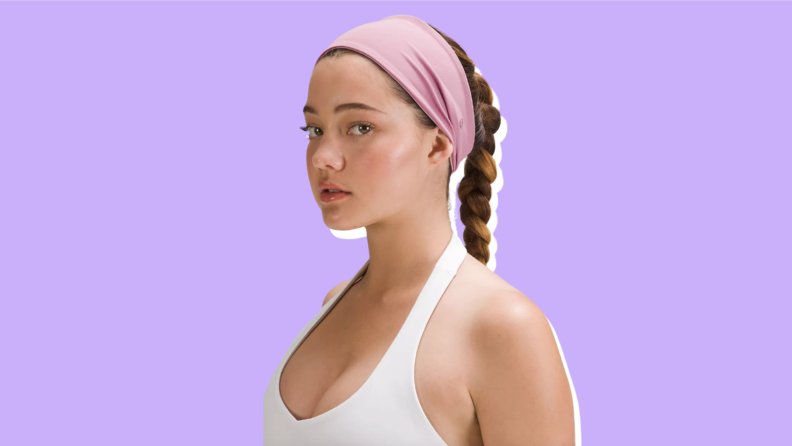 A woman wearing Lululemon Nulu Wide Reversible Headband.