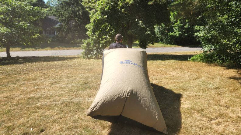 Terraking TerraKing 54 cubic foot Pro Leaf Bag strapped to the back of lawn mower.