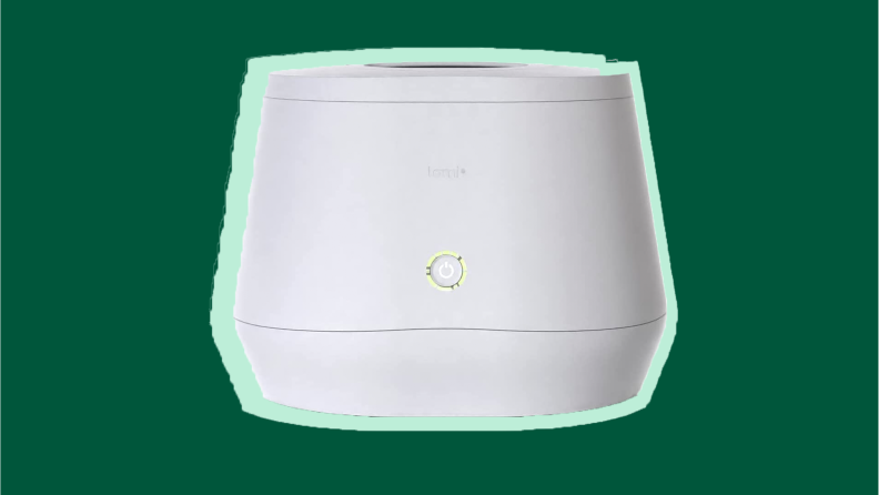 White composter on a green background