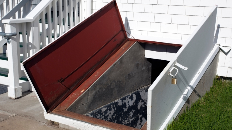 A storm cellar with open doors leading to underground shelter