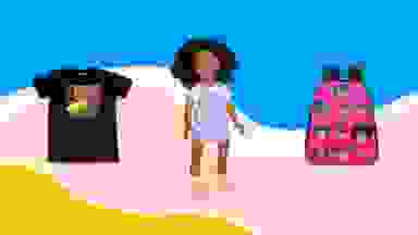 A black T-shirt, Black baby doll, and a pink backpack with illustrations of Black girls on it on a pink, yellow, and blue background.