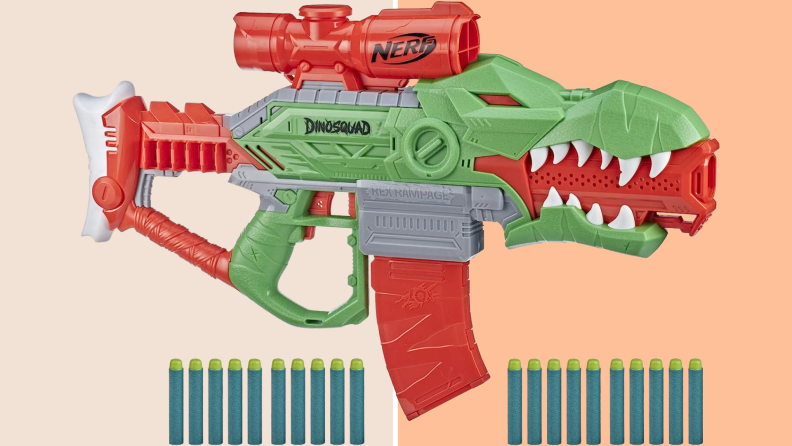 A Nerf DinoSquad blaster with darts lined up along the bottom set against a light peach colored background.