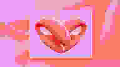 Two We-Vibe vibrators shaped into a heart on a purple and pink background.
