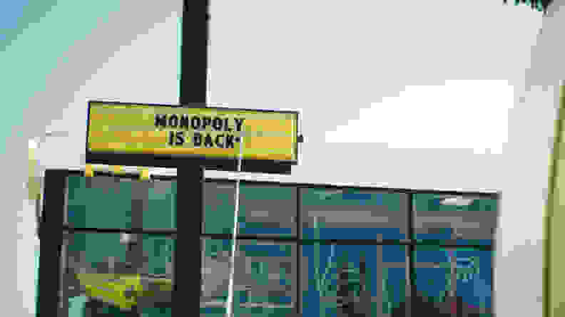 The exterior of a McDonalds and a sign reading, "Monopoly is back."