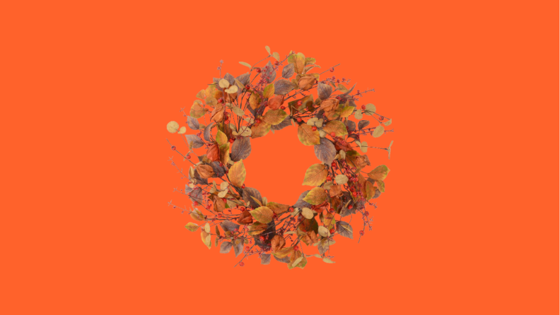 Brown door wreath against orange background