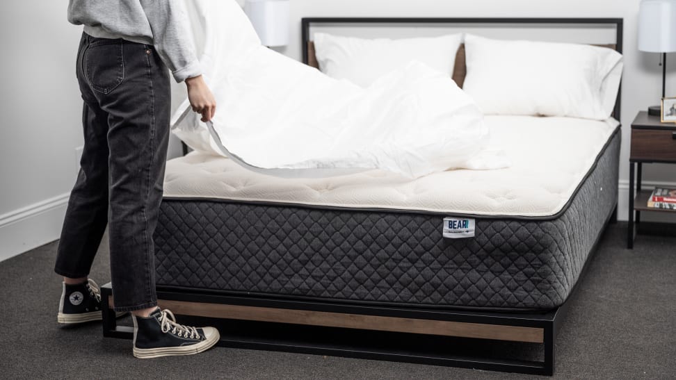 person puts cover on bear mattress