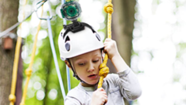 A boy slacklines with a Prograce mounted to his helmet.